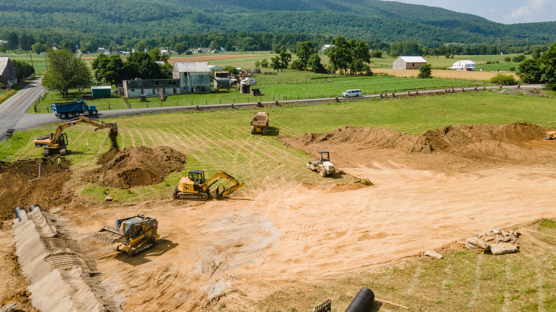 Excavators and heavy equipment preparing a rural building site