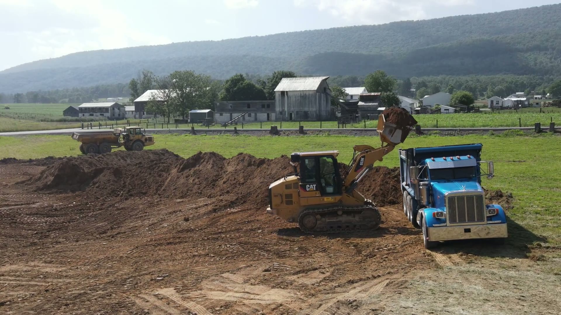 Sam's Backhoe Service equipment preparing a large rural job site